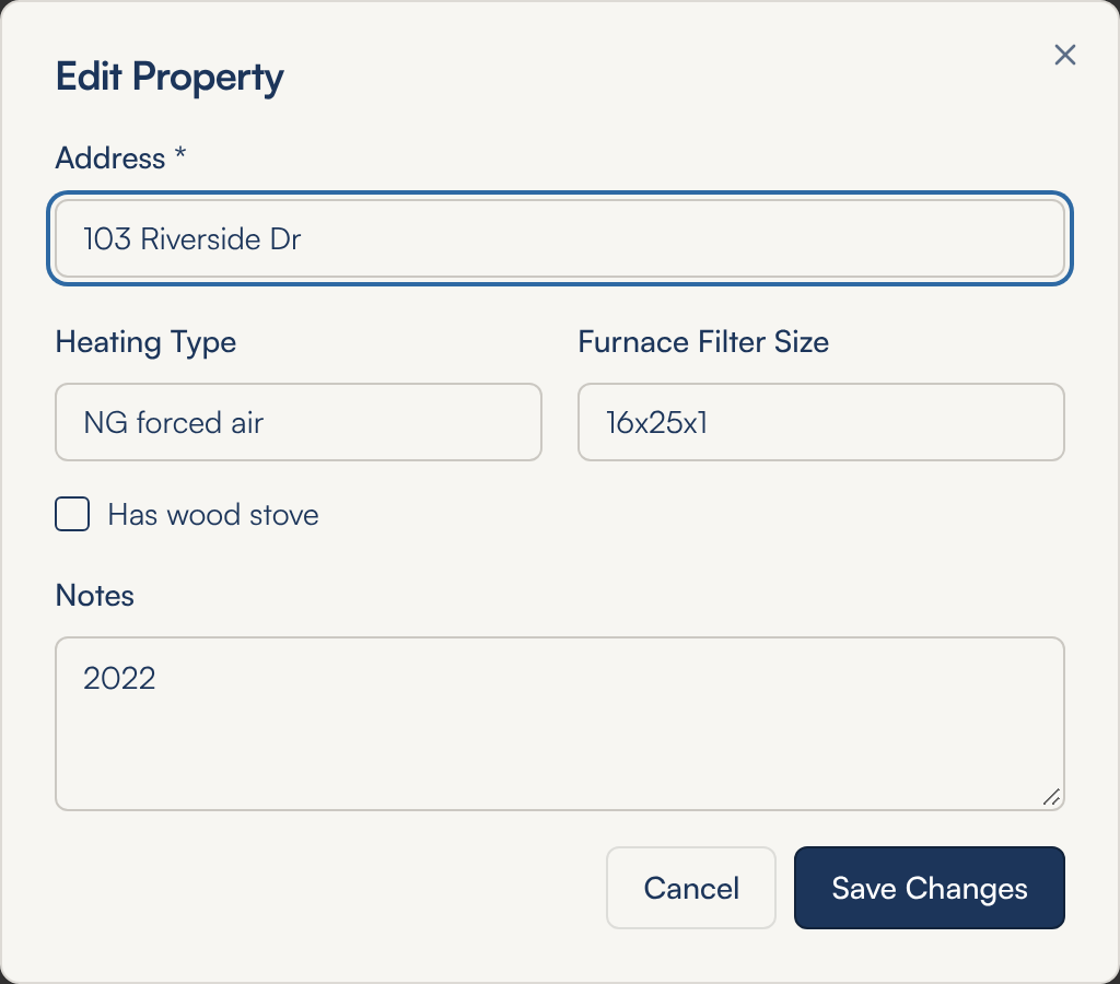 The Edit Property window with the address, heating type, furnace filter size, a Has wood stove tick box and notes already filled in, and Cancel and Save Changes buttons